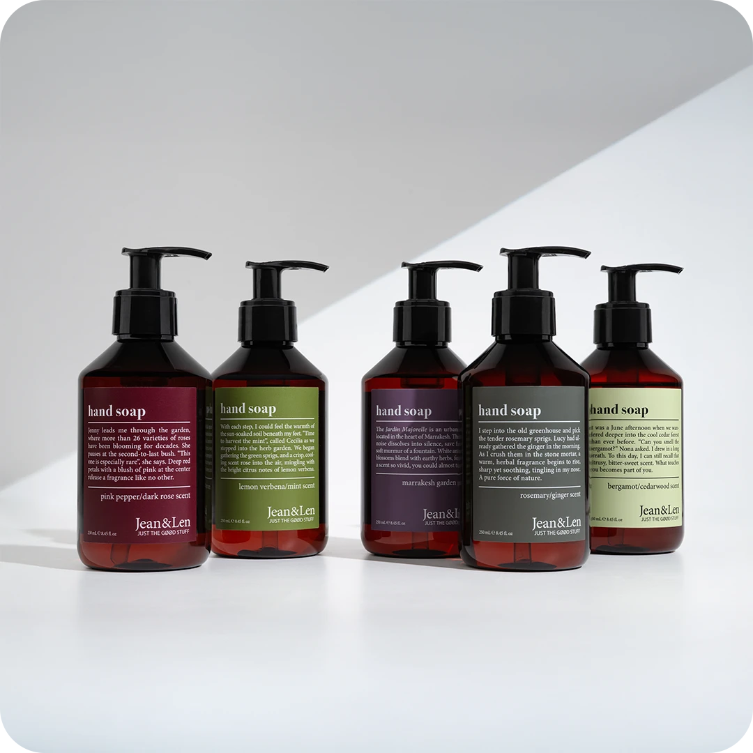 Five Jean&Len hand soap bottles with pump dispensers in different scents, showcasing minimalist design and vegan personal care products.